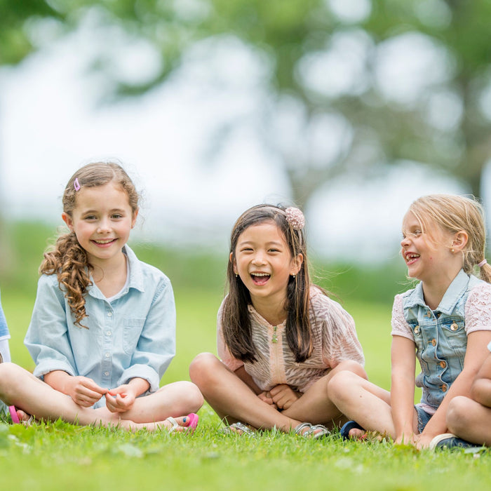5 children sitting on the grass. Toy store NZ, Toy Shop Auckland, Toy Shop Christchurch, Toy Shop Wellington, Toy shop Dunedin, Toy world, Toy Co, Toys r us.