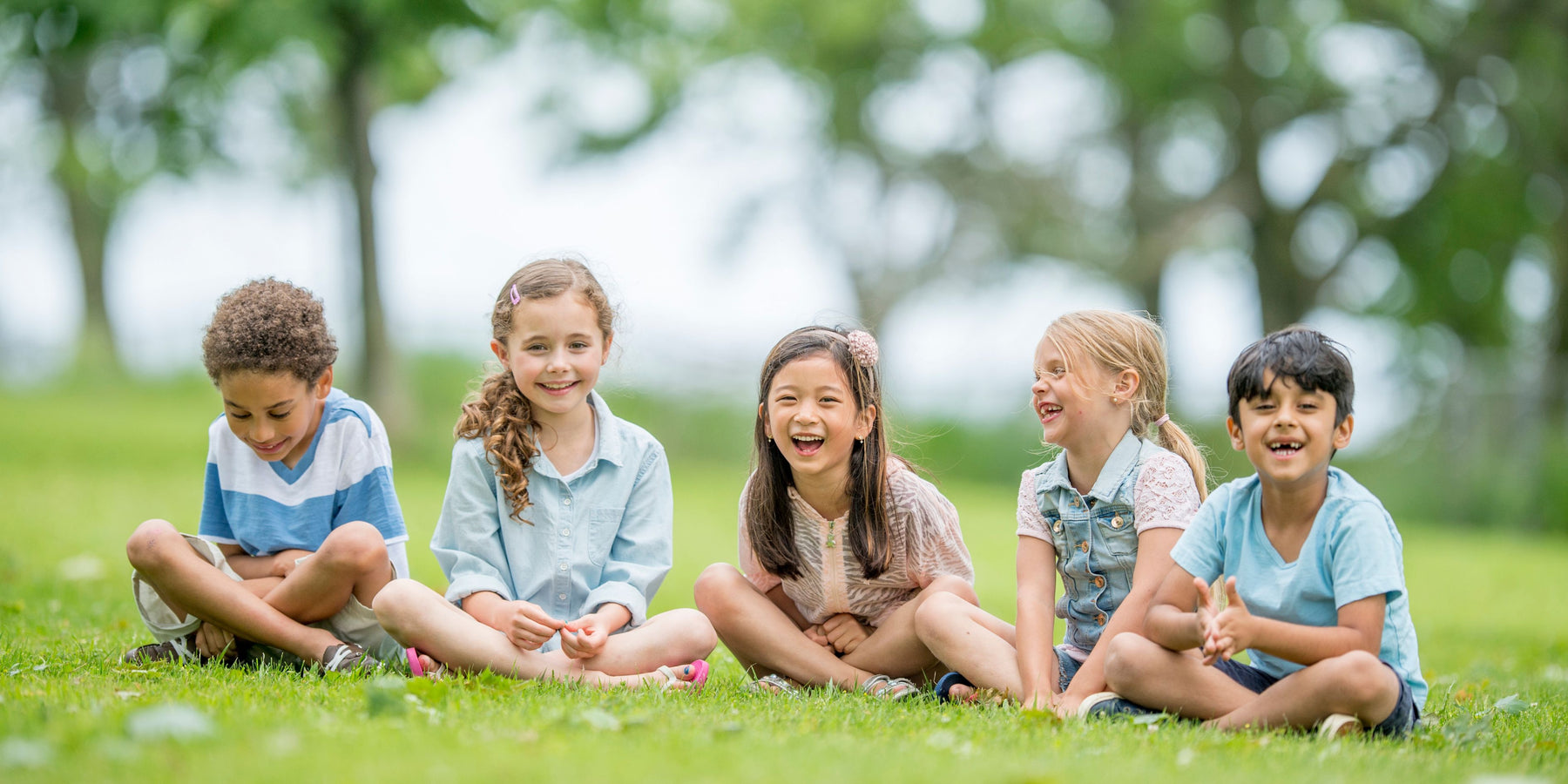 5 children sitting on the grass. Toy store NZ, Toy Shop Auckland, Toy Shop Christchurch, Toy Shop Wellington, Toy shop Dunedin, Toy world, Toy Co, Toys r us.