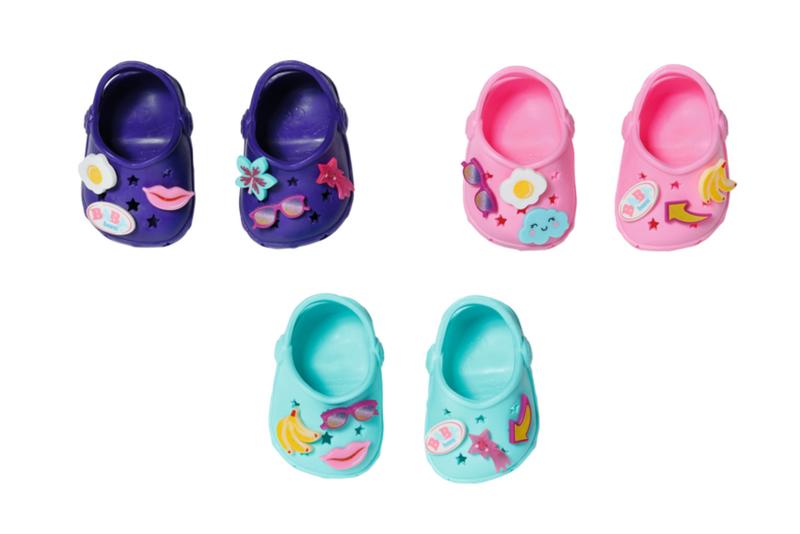 Set of colorful baby shoes with various designs on a white background