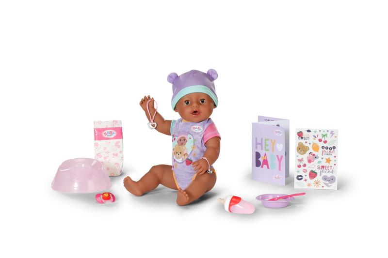Baby doll with accessories on a white background