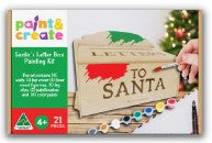 Paint & Crave Santa Letter packaging kit with a hand holding the box against a Christmas-themed background.
