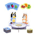Children's game set with cartoon character stands, cards, and food icons on a white background