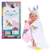 Baby doll with unicorn-themed towel and packaging on a white background