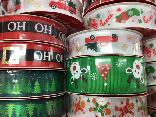 Stack of Christmas-themed ribbons with Santa Claus, reindeer, and gingerbread men designs.