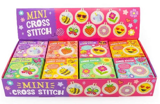 Box of mini cross stitch kits with colorful designs on a white background