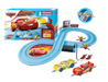 Toy car track set with cars and packaging featuring Disney/Pixar branding on a white background.