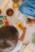 Child playing with educational cards on a carpeted floor
