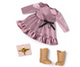 Pink dress with ruffles, brown boots, and a gift box on a white background