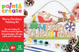 Christmas painting kit with wooden figure, paintbrushes, and paints on a white background
