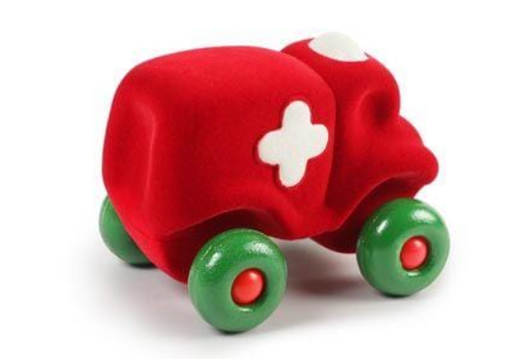 Red toy ambulance with green wheels on a white background