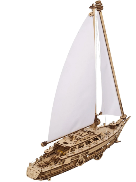 Wooden sailboat model with white sails on a white background