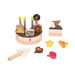 Toy birthday cake set with candles, slices, and accessories on a white background